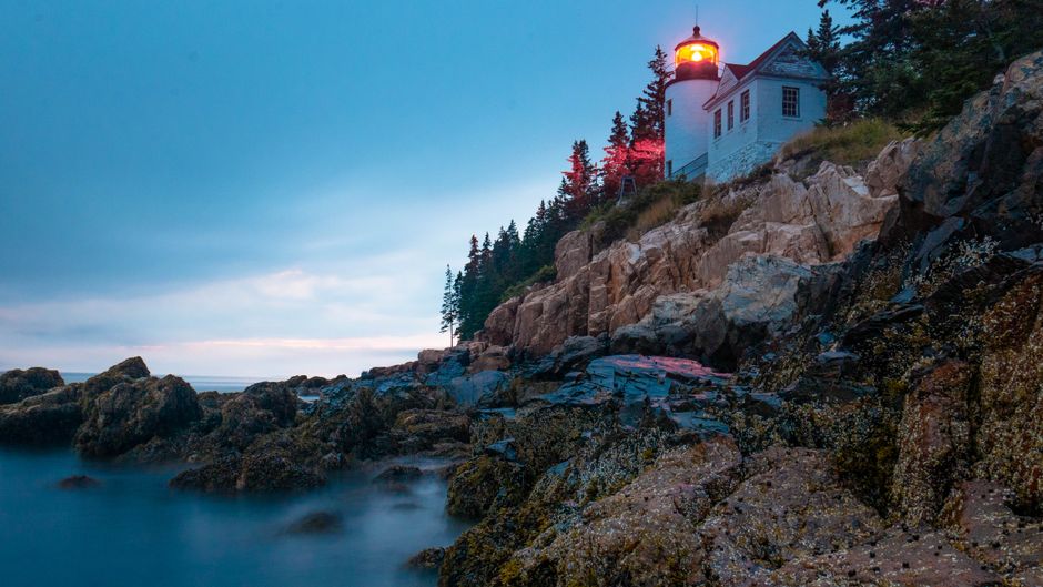 Rocky Acadia coastline and lighthouse in Maine