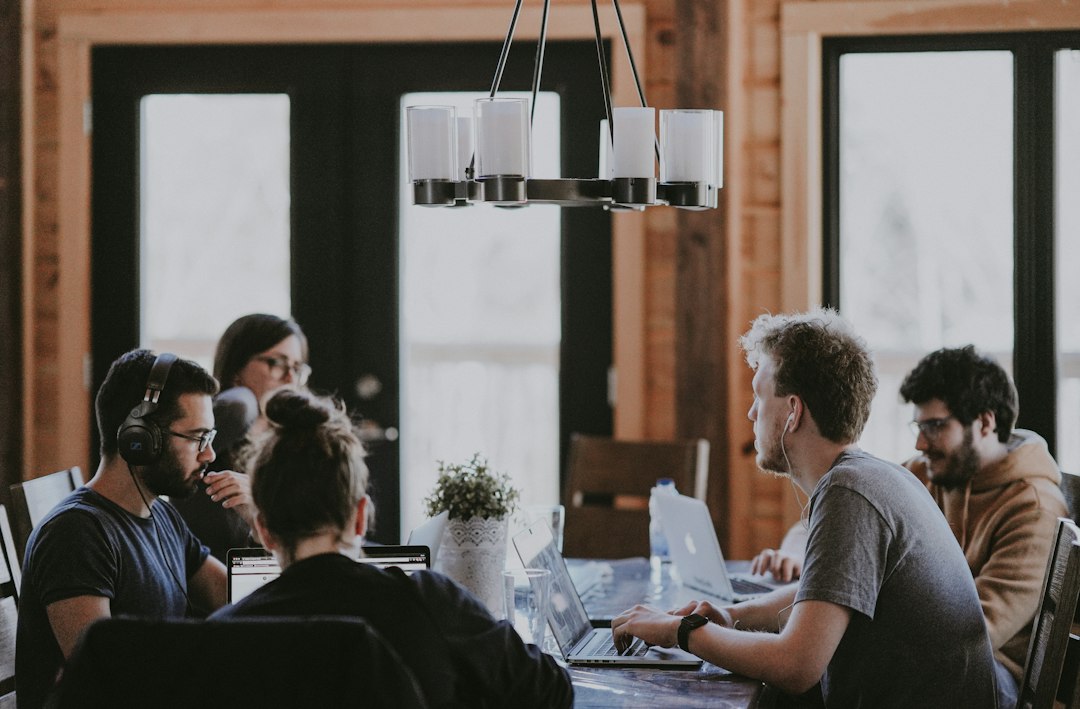 Colleagues sit together in a meeting room.