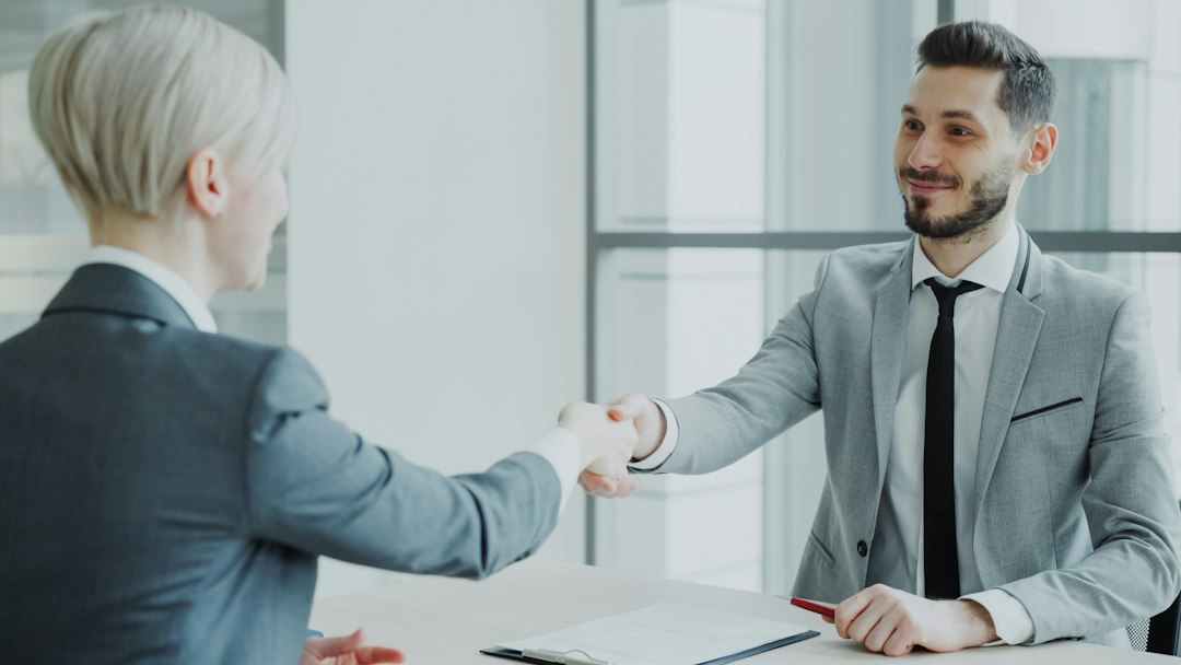 Professional man and woman shaking hands during a business meeting