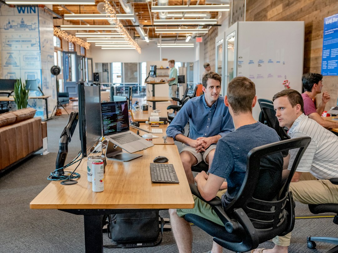 Colleagues sit together at a meeting table.