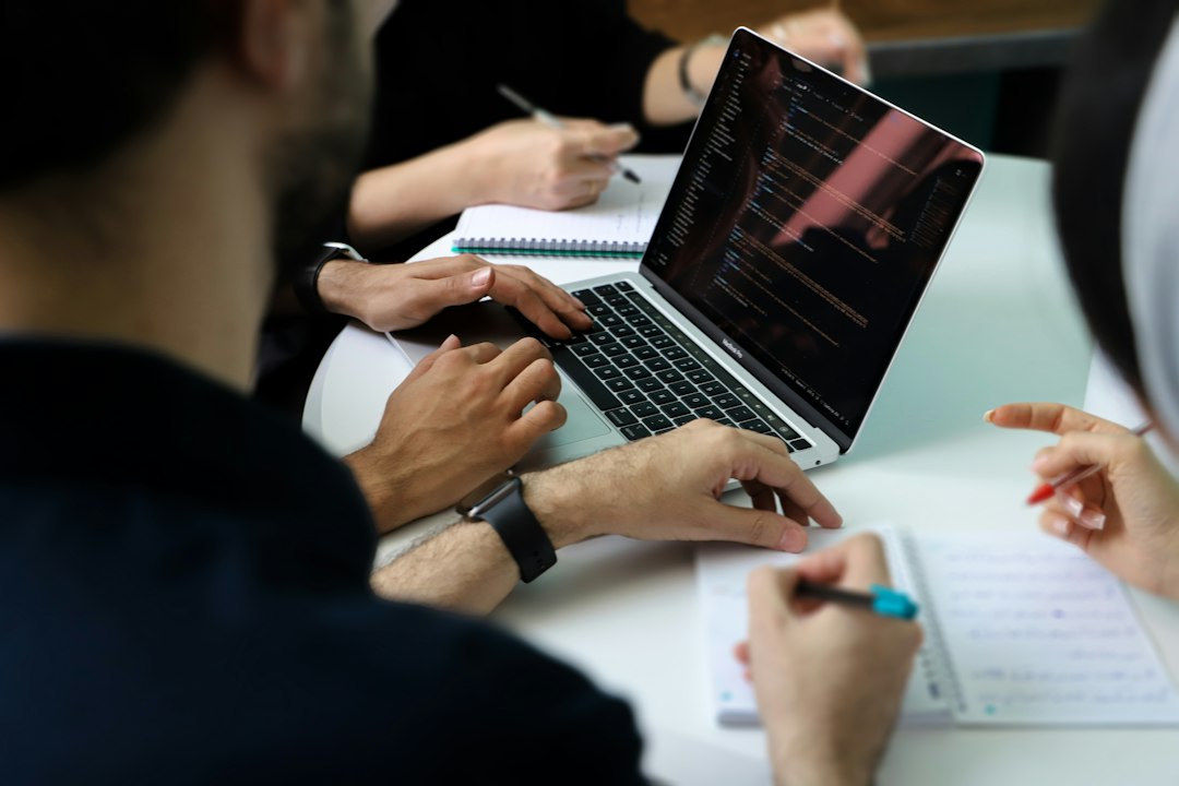 A team meets around a laptop.