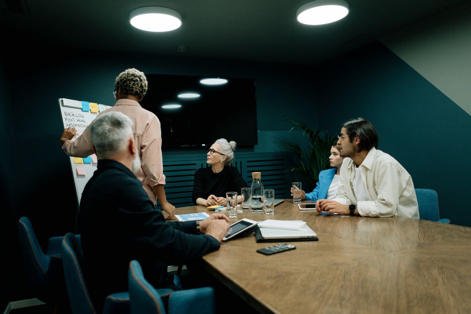A diverse team discusses business strategy in an office.
