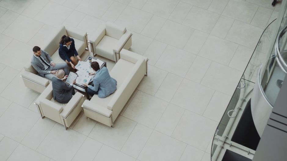 A team reviews documents from around a modern office table.