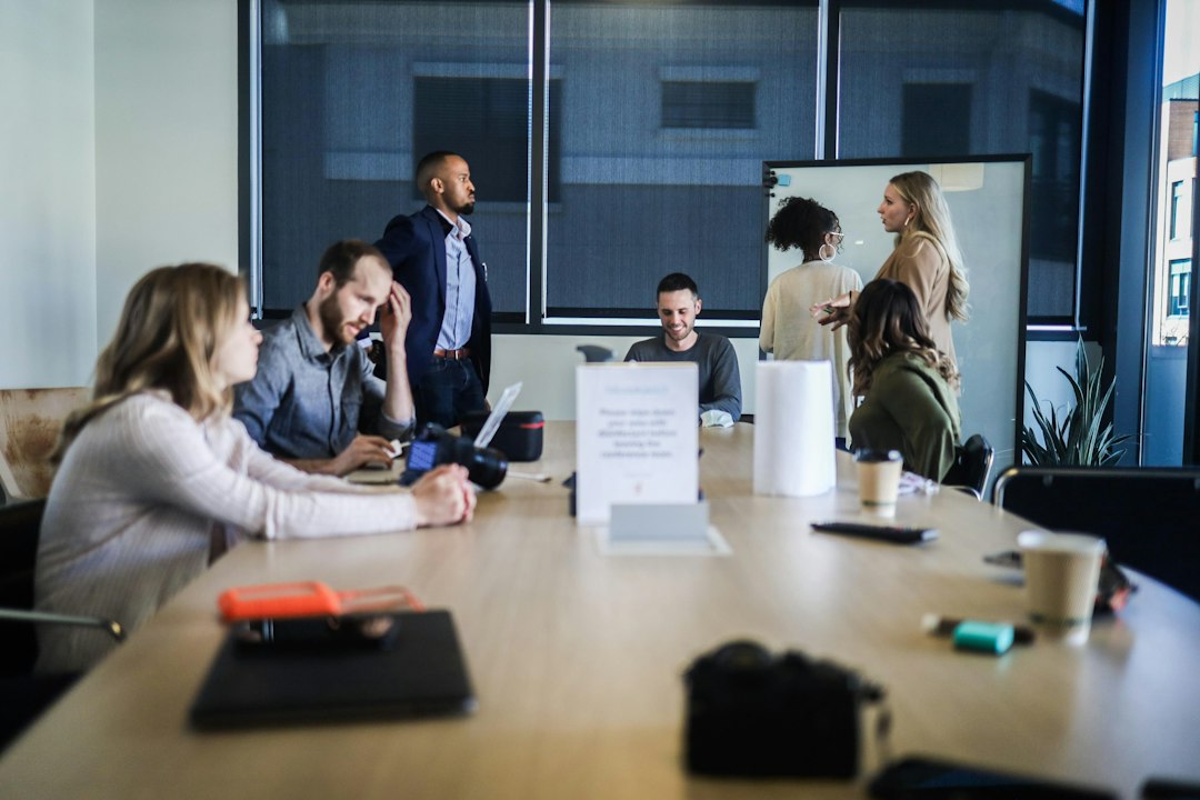 People sit together around a table during a business meeting.